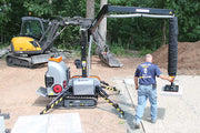 Person operating Allrounder on a construction site with trees in the background
