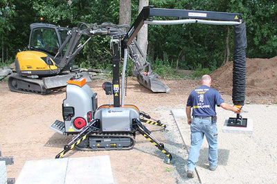 Person operating Allrounder on a construction site with trees in the background